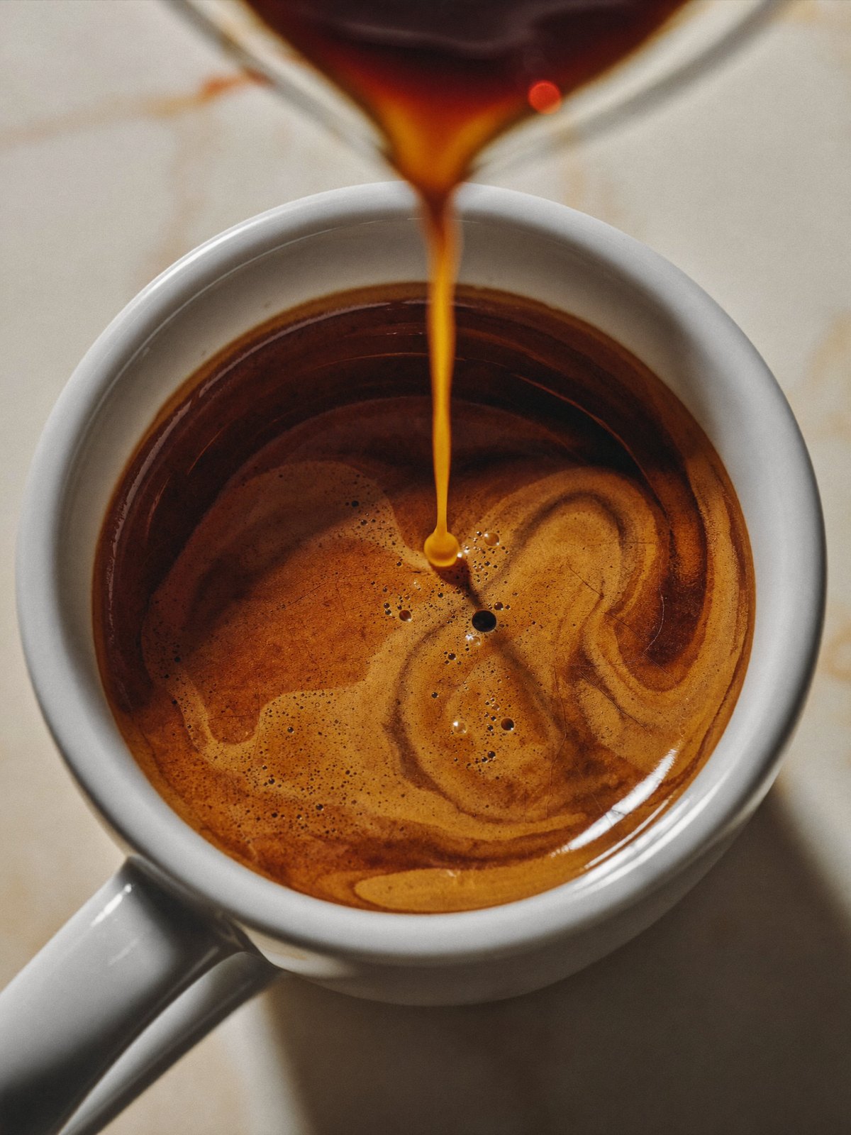 Espresso pouring into a cup